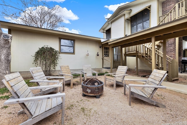 view of patio featuring a fire pit and stairs