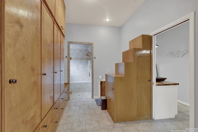 interior space with baseboards and light tile patterned floors