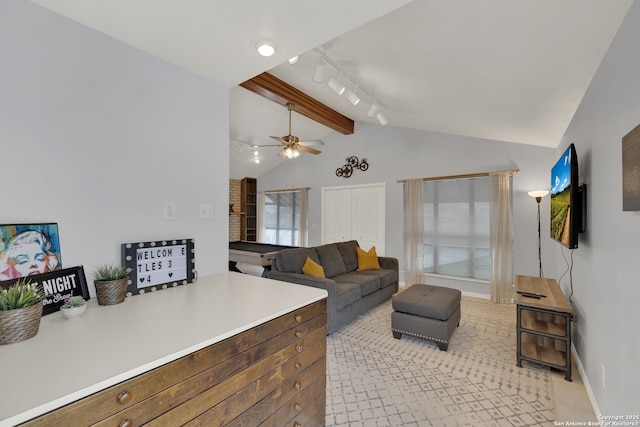 living area with vaulted ceiling with beams, baseboards, a ceiling fan, and track lighting