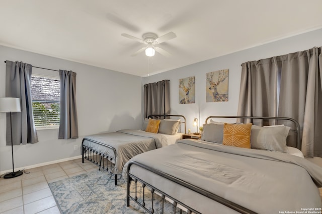 bedroom featuring ceiling fan, baseboards, and tile patterned floors