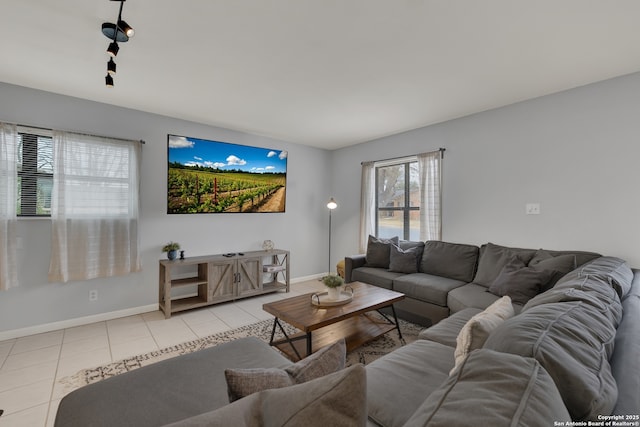 living room featuring baseboards and light tile patterned floors