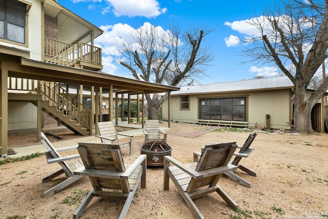 view of patio / terrace with an outdoor fire pit and stairway