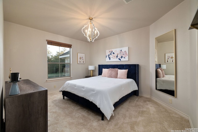 bedroom featuring light carpet, a notable chandelier, and baseboards