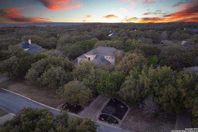 drone / aerial view featuring a forest view