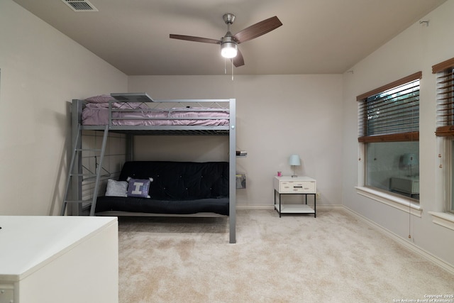 bedroom featuring ceiling fan, carpet flooring, visible vents, and baseboards