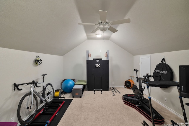 workout area featuring vaulted ceiling, carpet floors, a ceiling fan, and baseboards