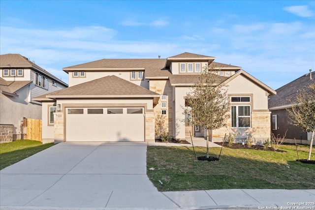 view of front facade featuring driveway, roof with shingles, an attached garage, a front yard, and stucco siding