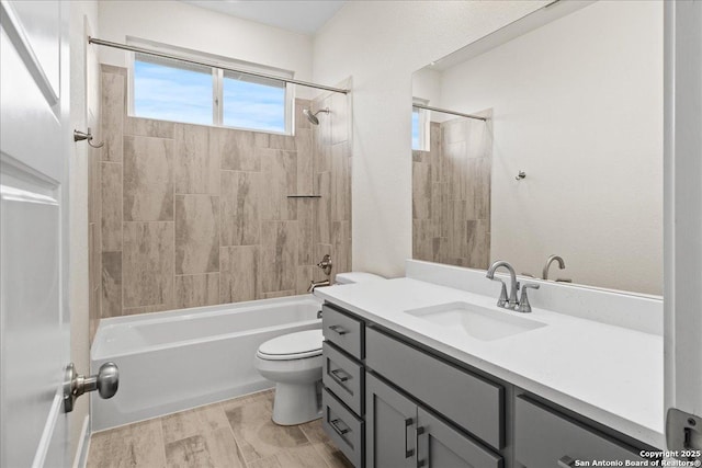 full bath with toilet, vanity, wood finished floors, and shower / bathing tub combination