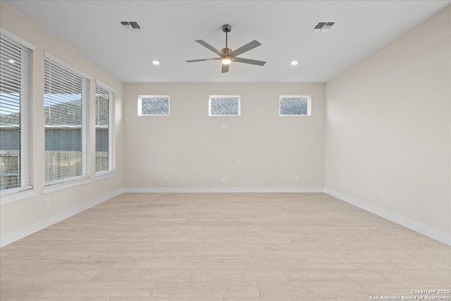 empty room with visible vents, plenty of natural light, and light wood-style flooring