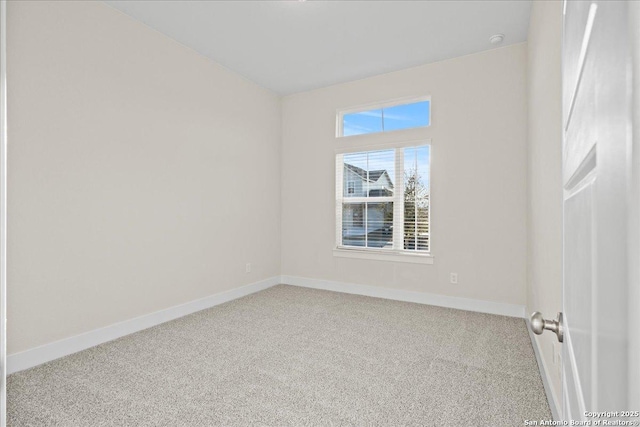 unfurnished room with carpet and baseboards