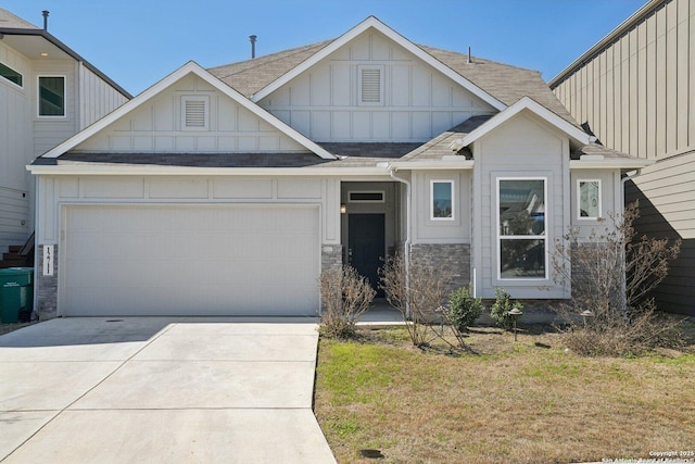 view of front facade with an attached garage, concrete driveway, stone siding, a front lawn, and board and batten siding