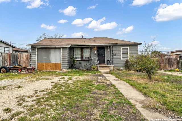 view of front of property with a garage and fence