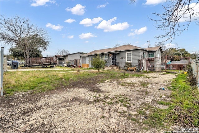 rear view of house featuring fence