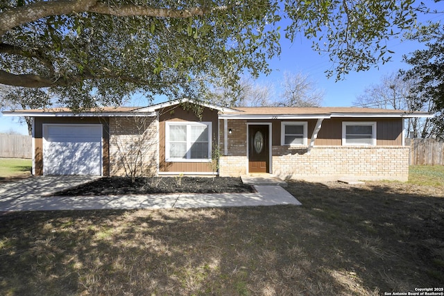 ranch-style home with a garage, a front yard, fence, and brick siding