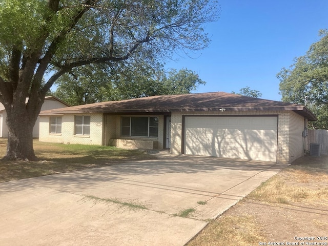 ranch-style home with driveway, brick siding, and an attached garage