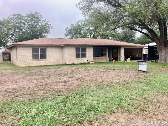 single story home with brick siding and a front lawn