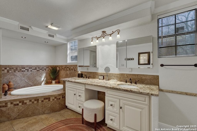 bathroom featuring tile patterned flooring, crown molding, visible vents, and a sink