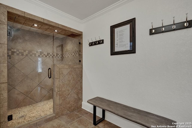 full bath with a stall shower, baseboards, ornamental molding, and tile patterned floors