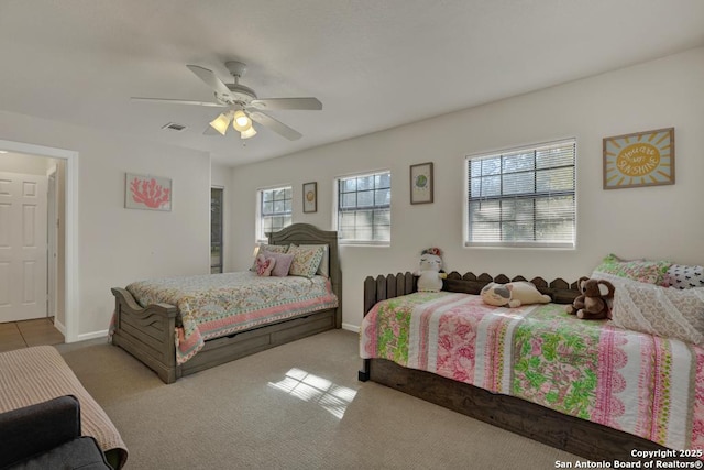 carpeted bedroom with visible vents, ceiling fan, and baseboards