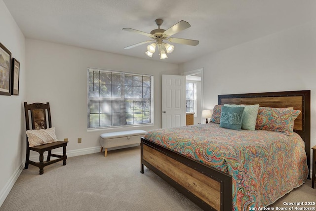 bedroom with baseboards, a ceiling fan, and light colored carpet