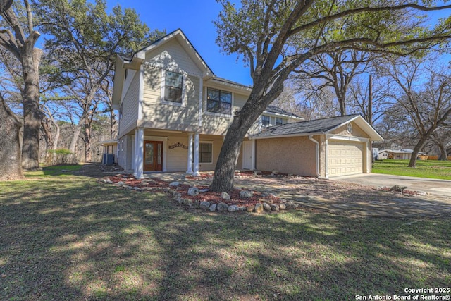 traditional-style home featuring a garage and a front lawn