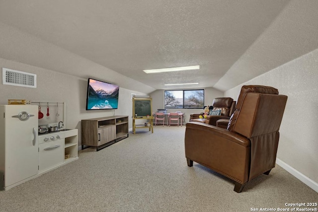 interior space featuring lofted ceiling, visible vents, a textured ceiling, and baseboards