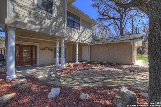 property entrance with stucco siding