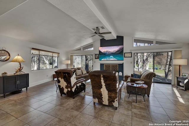 tiled living room with lofted ceiling with beams, ceiling fan, a fireplace, and baseboards