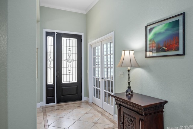 entrance foyer with ornamental molding, baseboards, and light tile patterned floors