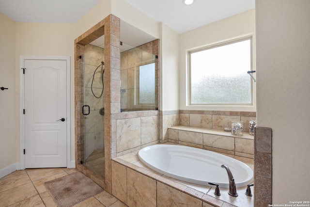 bathroom with a stall shower and a bath