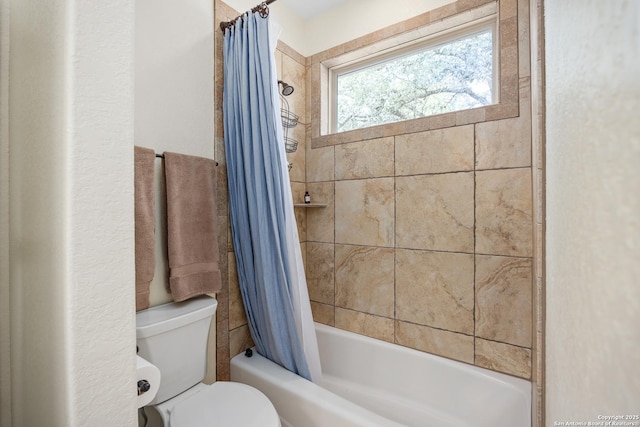 bathroom featuring toilet and shower / tub combo with curtain