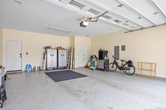 garage featuring electric panel and a garage door opener