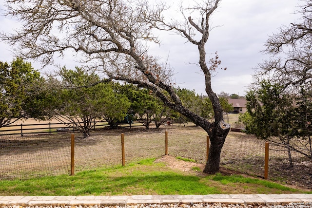 view of yard with a rural view and fence