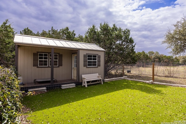 exterior space with an outbuilding and fence