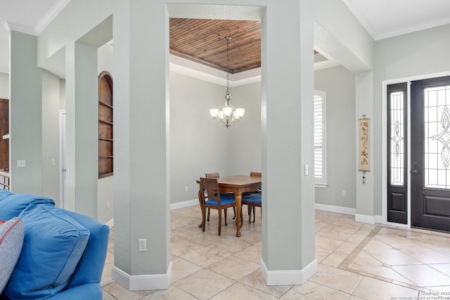 foyer entrance featuring a notable chandelier, crown molding, baseboards, and light tile patterned floors