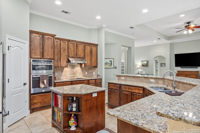 kitchen featuring visible vents, black electric stovetop, stainless steel double oven, under cabinet range hood, and a sink