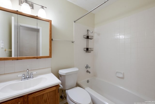 bathroom featuring toilet, washtub / shower combination, a textured ceiling, and vanity