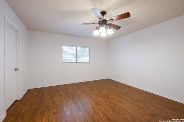 empty room with a ceiling fan, a textured ceiling, baseboards, and wood finished floors