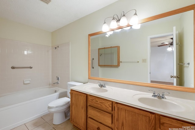 bathroom featuring a textured ceiling, a sink, toilet, and tile patterned floors