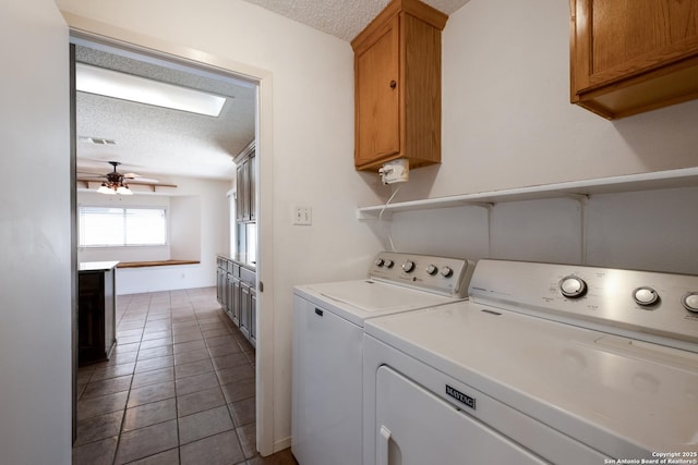 washroom with washing machine and dryer, cabinet space, ceiling fan, and a textured ceiling