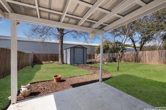 view of yard with a fenced backyard, an outdoor structure, a patio, and a shed