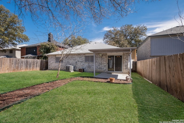 rear view of house featuring brick siding, a yard, central AC unit, a patio area, and a fenced backyard