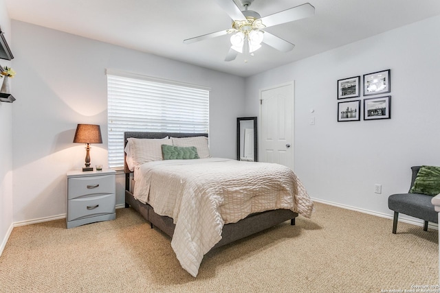 bedroom with baseboards, a ceiling fan, and light colored carpet