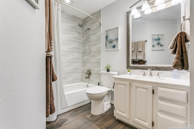 bathroom featuring toilet, wood tiled floor, shower / washtub combination, and vanity