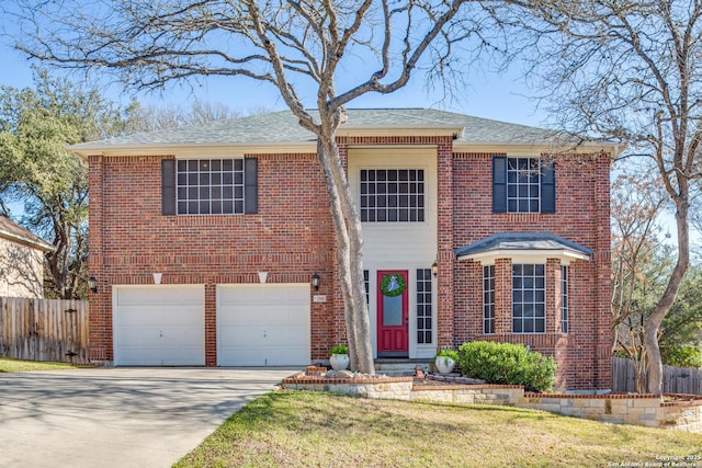 view of front of house featuring a garage, brick siding, fence, concrete driveway, and a front lawn