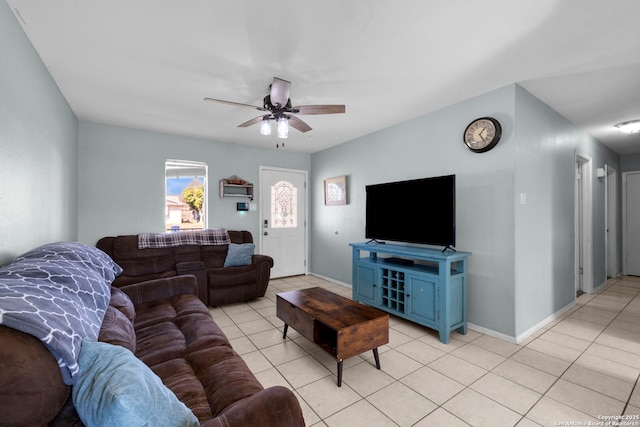 living room with light tile patterned floors, ceiling fan, and baseboards