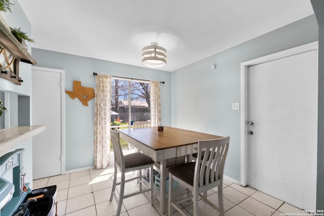 dining area with light tile patterned floors and baseboards