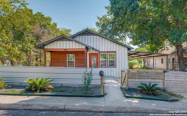 view of front facade featuring board and batten siding and a fenced front yard