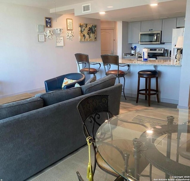 living area featuring visible vents and baseboards