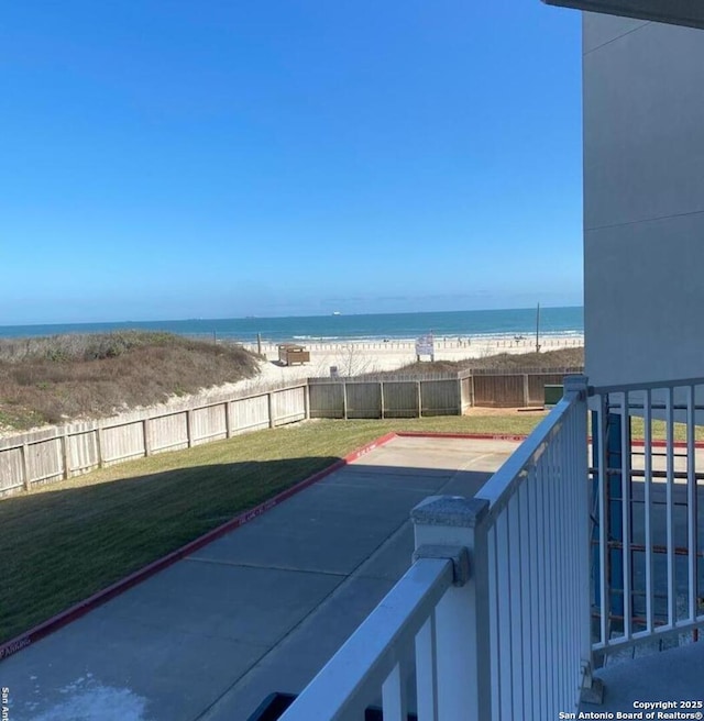 exterior space with a water view and a beach view